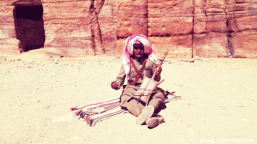 A Bedouin playing am indigenous musical instrument 