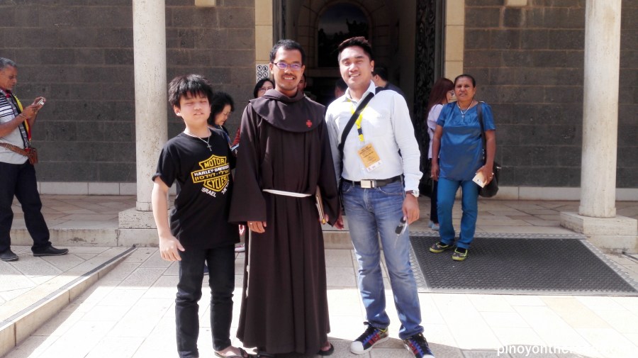 Posing for a souvenir picture of the Malaysian Priest who officiated the mass